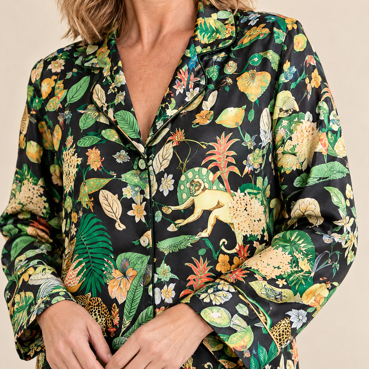 Close-up of the satin sleeves and golden piped cuffs on the Black Jungle Leopard pyjama top