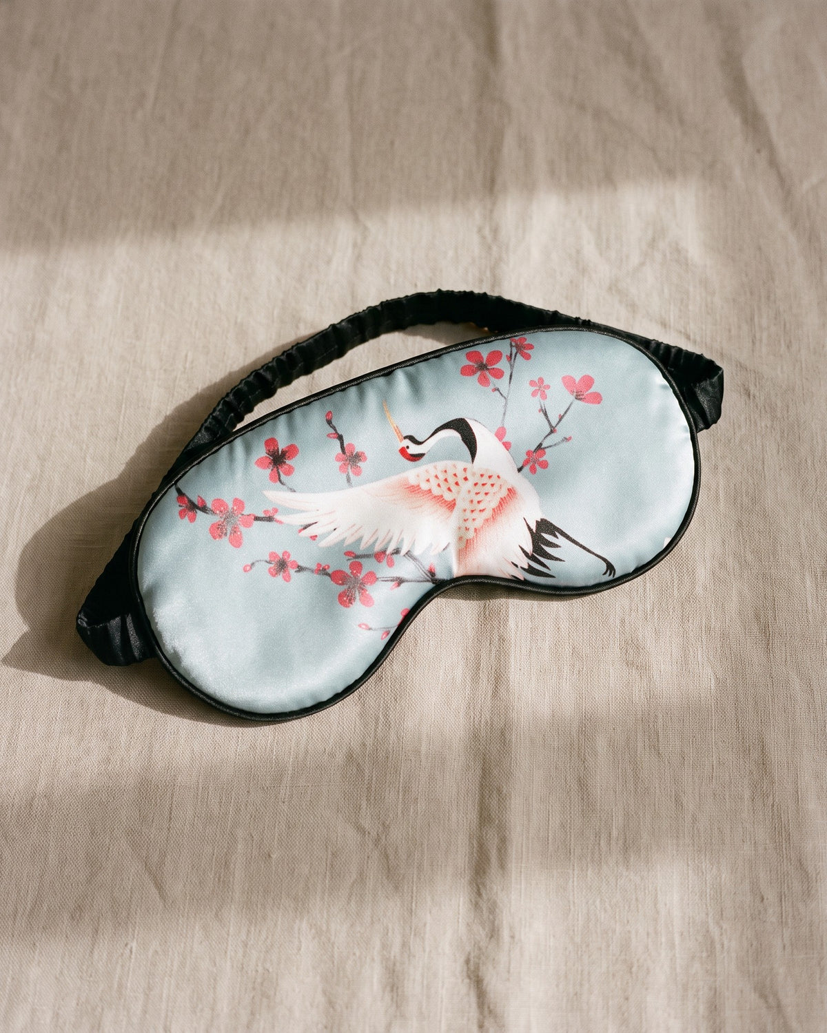 The Sakura Satin Eye Mask in Light Blue, front view
