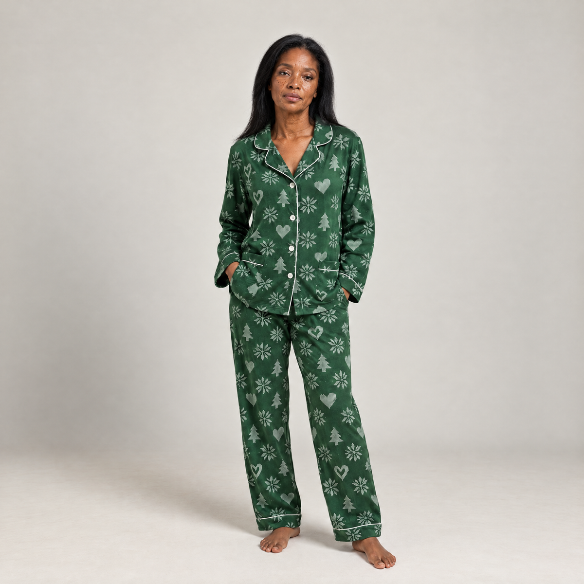 Woman wearing blue striped cotton flannel pyjamas with pink hearts and contrast piping