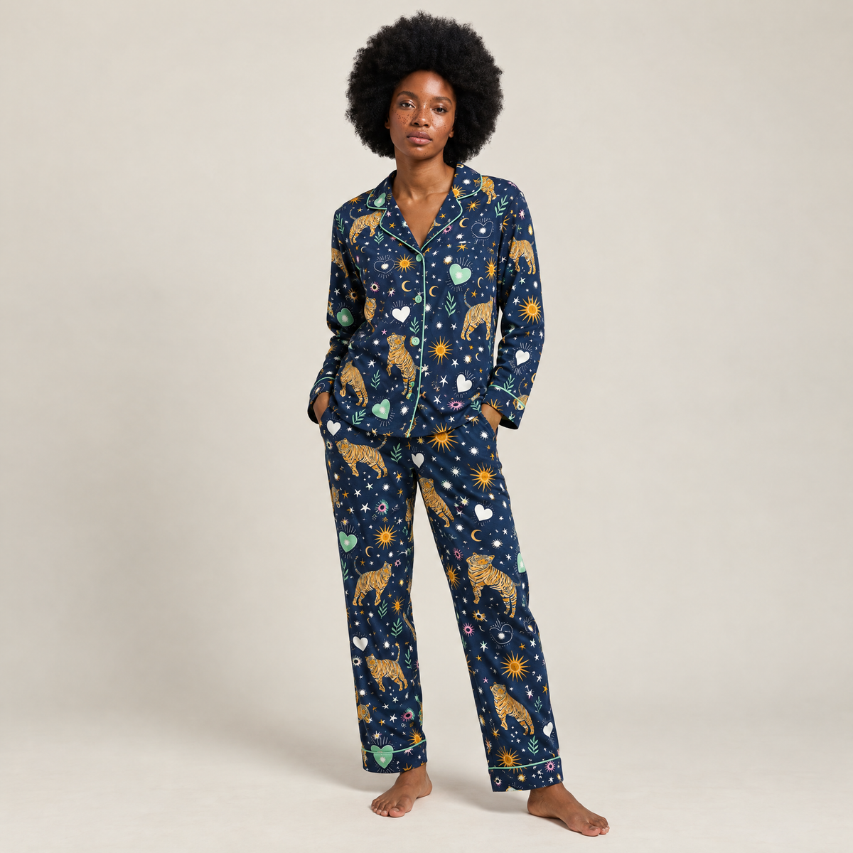 Woman wearing navy galaxy tiger print cotton flannel pyjamas with tigers, suns and stars, front view