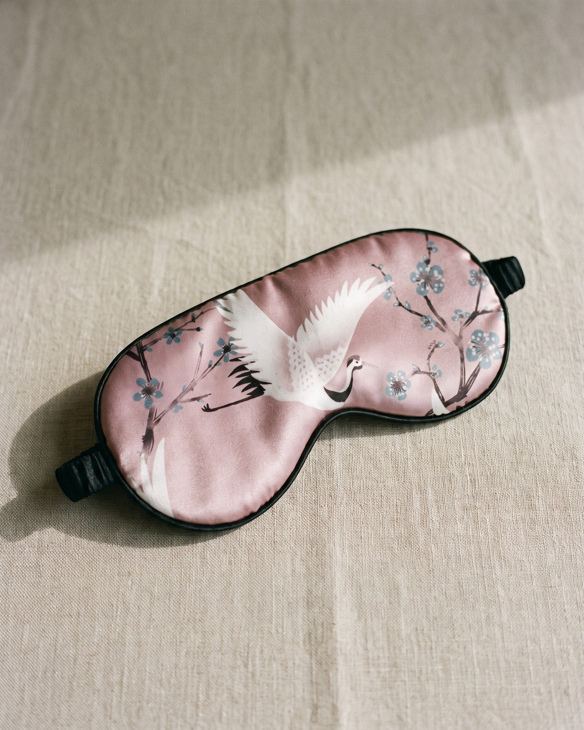 Night Owl Pyjamas Sakura Satin Eye Mask in pink, shown from the front