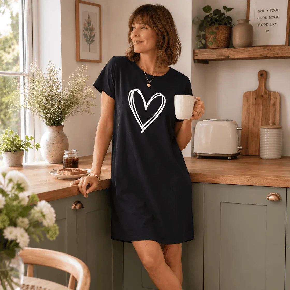 Woman wearing a navy blue Night Owl Pyjamas lightweight nightdress with a white heart design.
