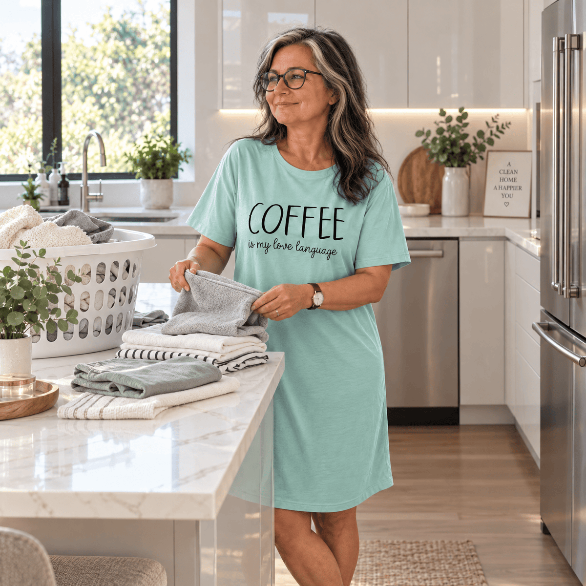 Woman in a mint green Night Owl Pyjamas oversized nightdress with coffee text in a kitchen.
