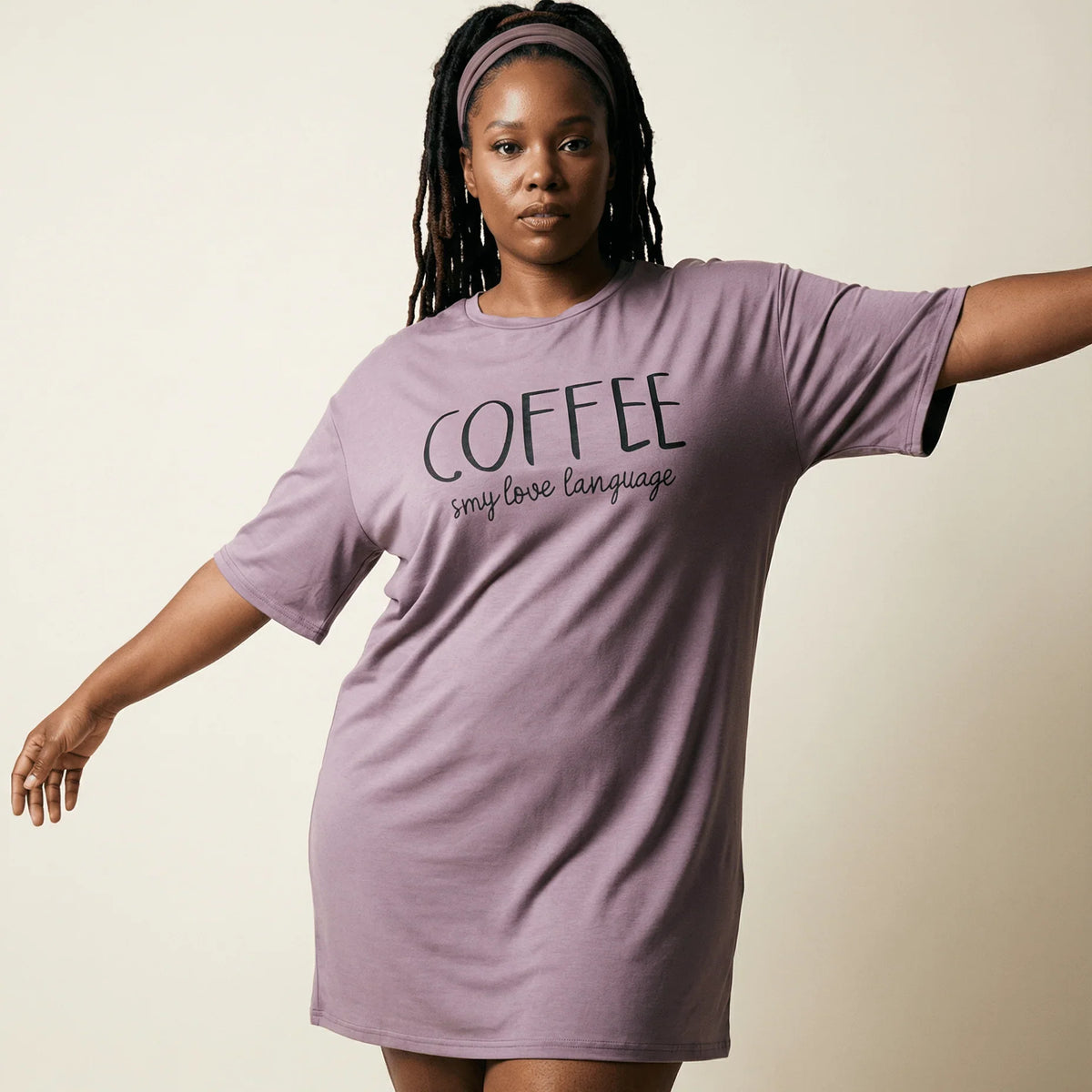 Woman wearing a purple oversized Night Owl Pyjamas nightdress with 'COFFEE' text.