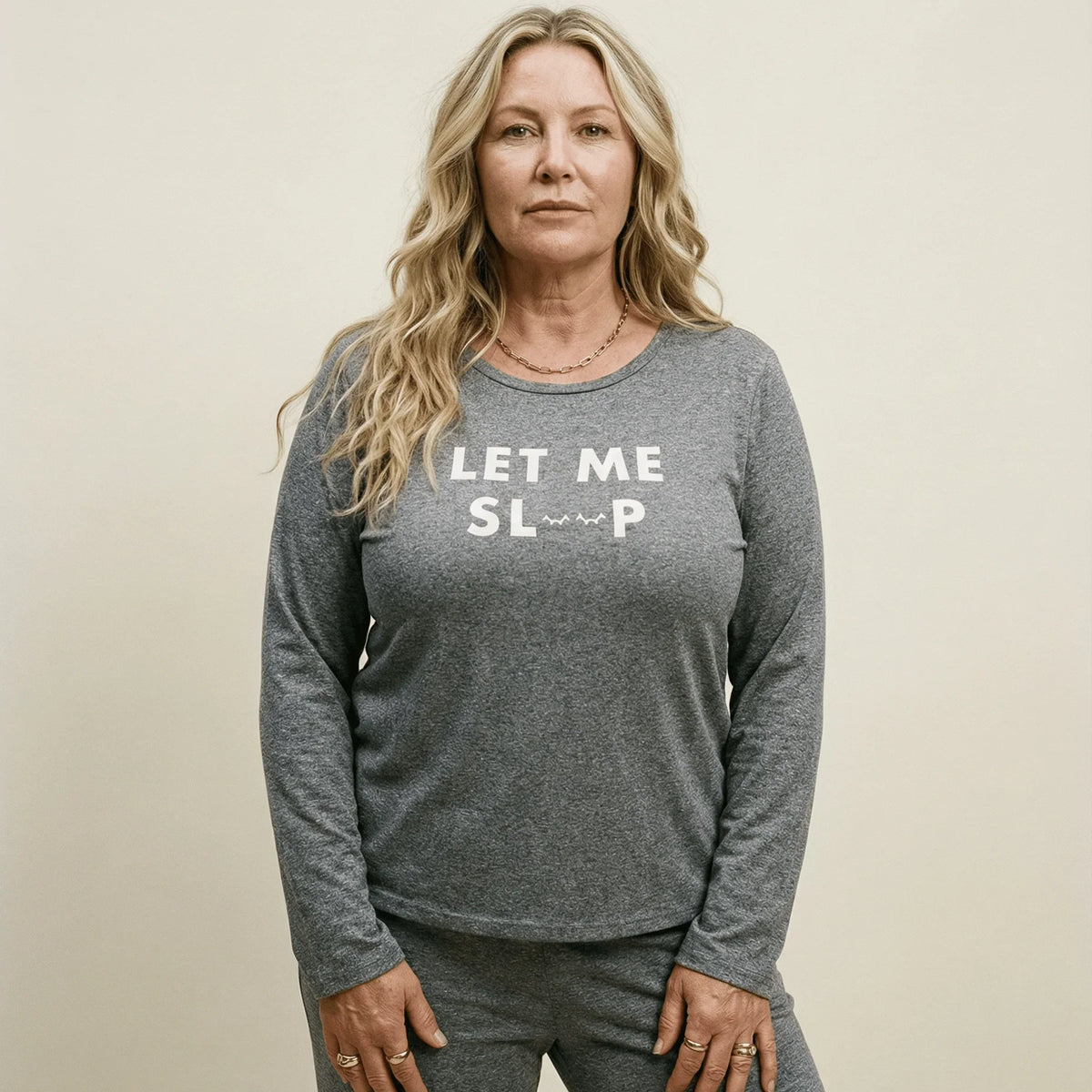 Woman wearing a grey Night Owl Pyjamas lightweight long sleeve top with 'LET ME SLEEP' text.